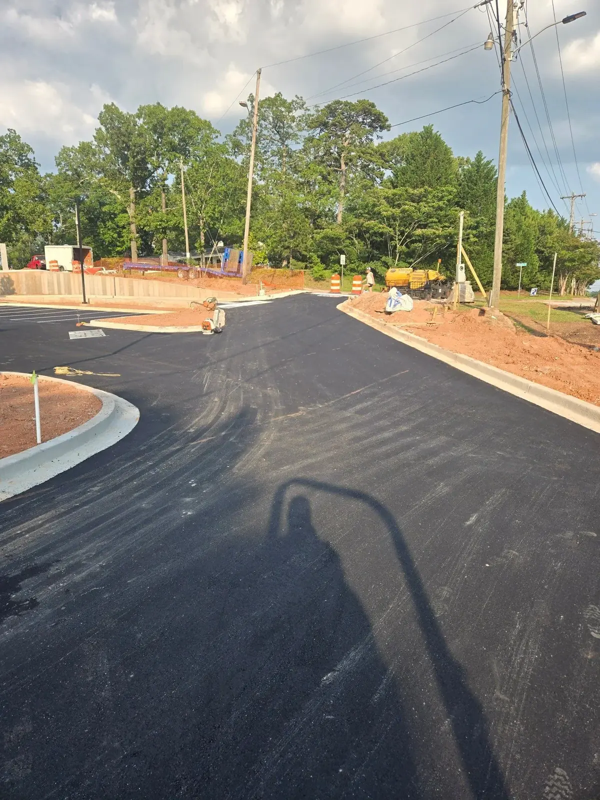 New asphalt entrance lined with concrete curbing