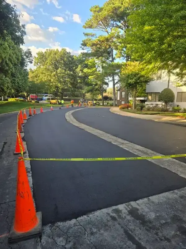 New asphalt with traffic cones set out around the work area