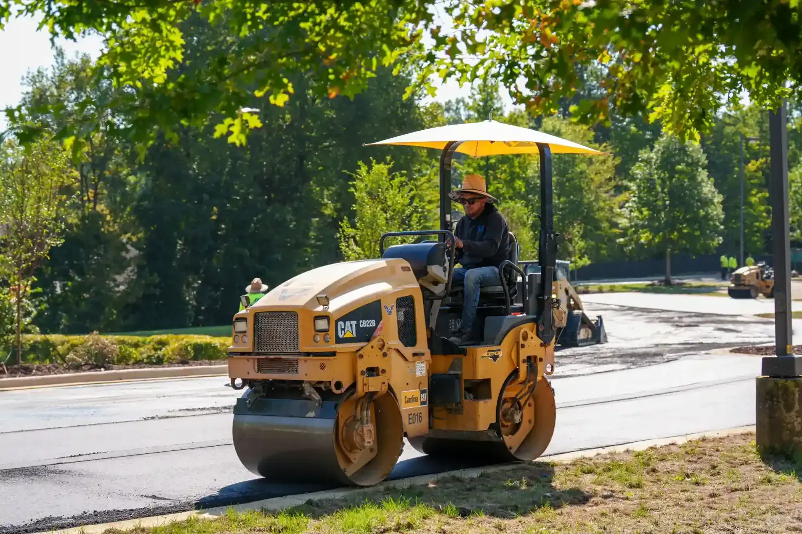 Roller compacting new asphalt on a commercial parking lot